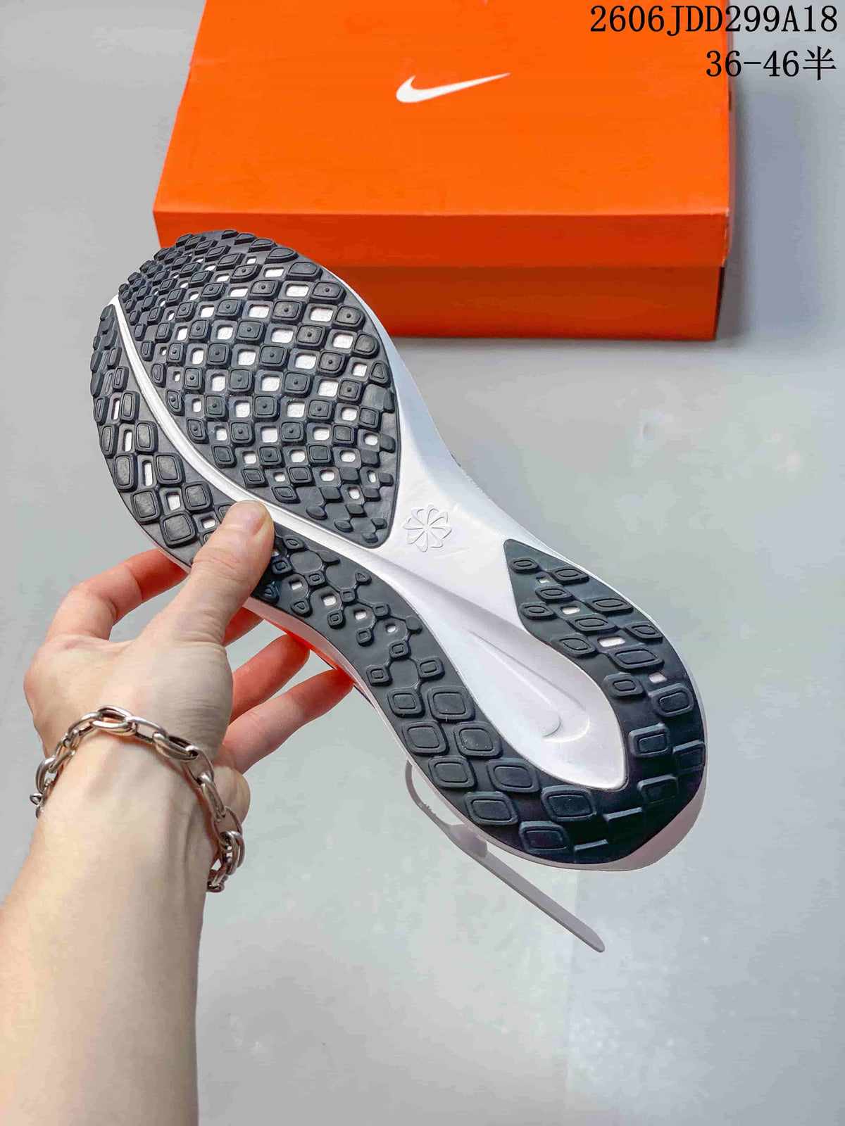 Close view of the patterned black outsole on a Nike Pegasus running shoe.