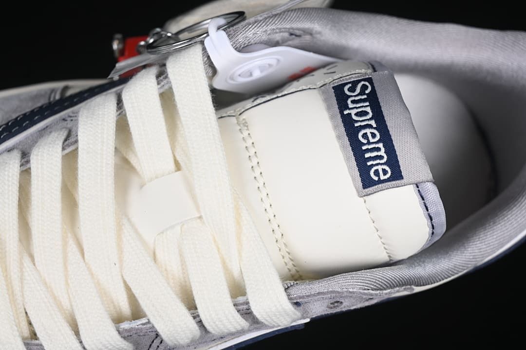 Close-up of tongue branding and cream-colored laces