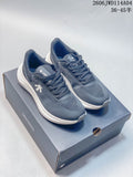 Pair of blue-gray DESCENTE low-top sneakers with white midsoles, shown on a DESCENTE shoe box.
