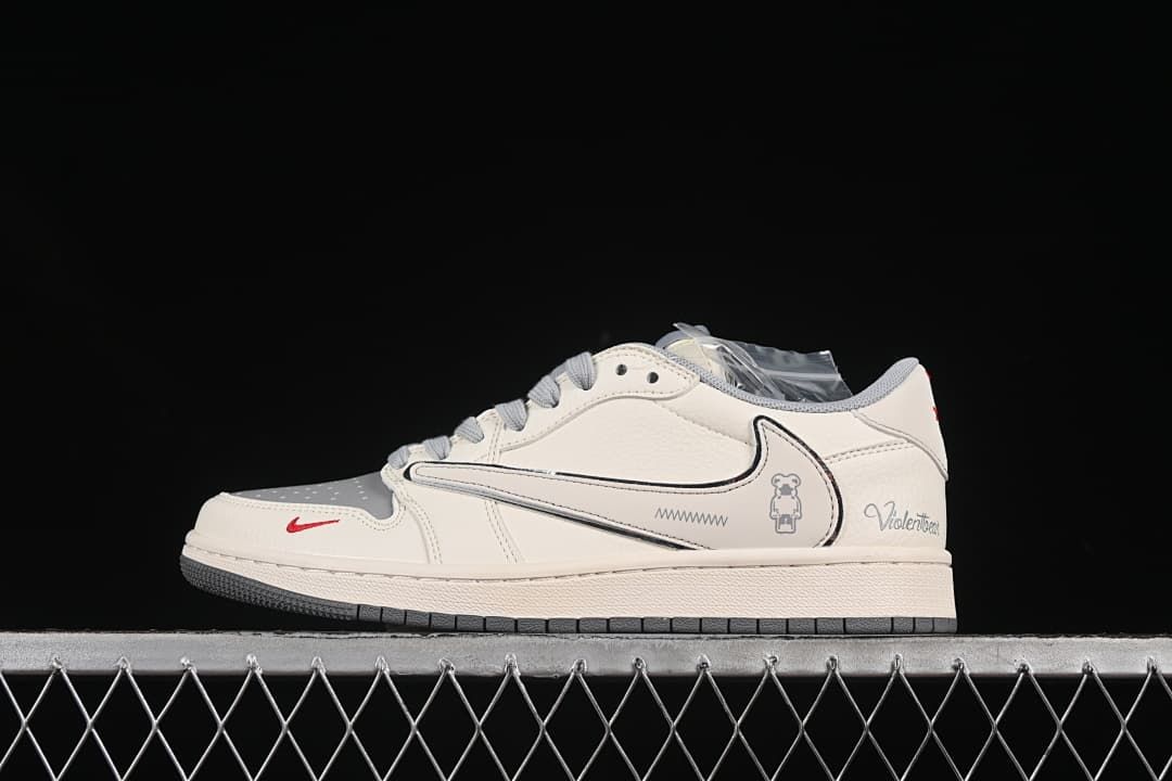 Side view of an off-white and gray low-top sneaker with an outlined oversized Swoosh, character graphic, and red accent.