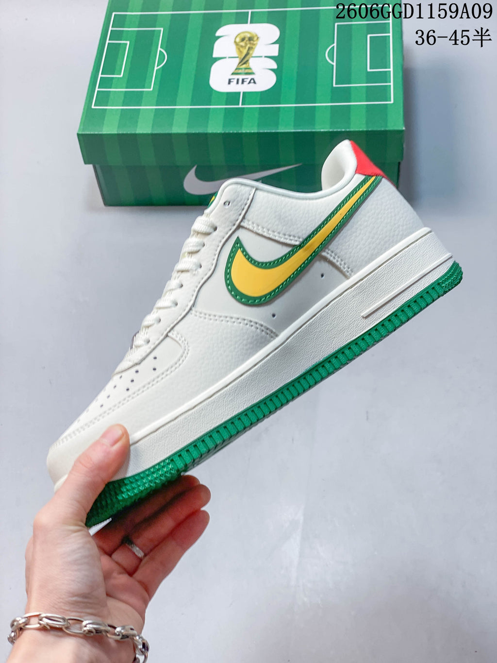 Side view of a white low-top sneaker with yellow-and-green Swoosh and green outsole; image overlay reads 36–45.5.