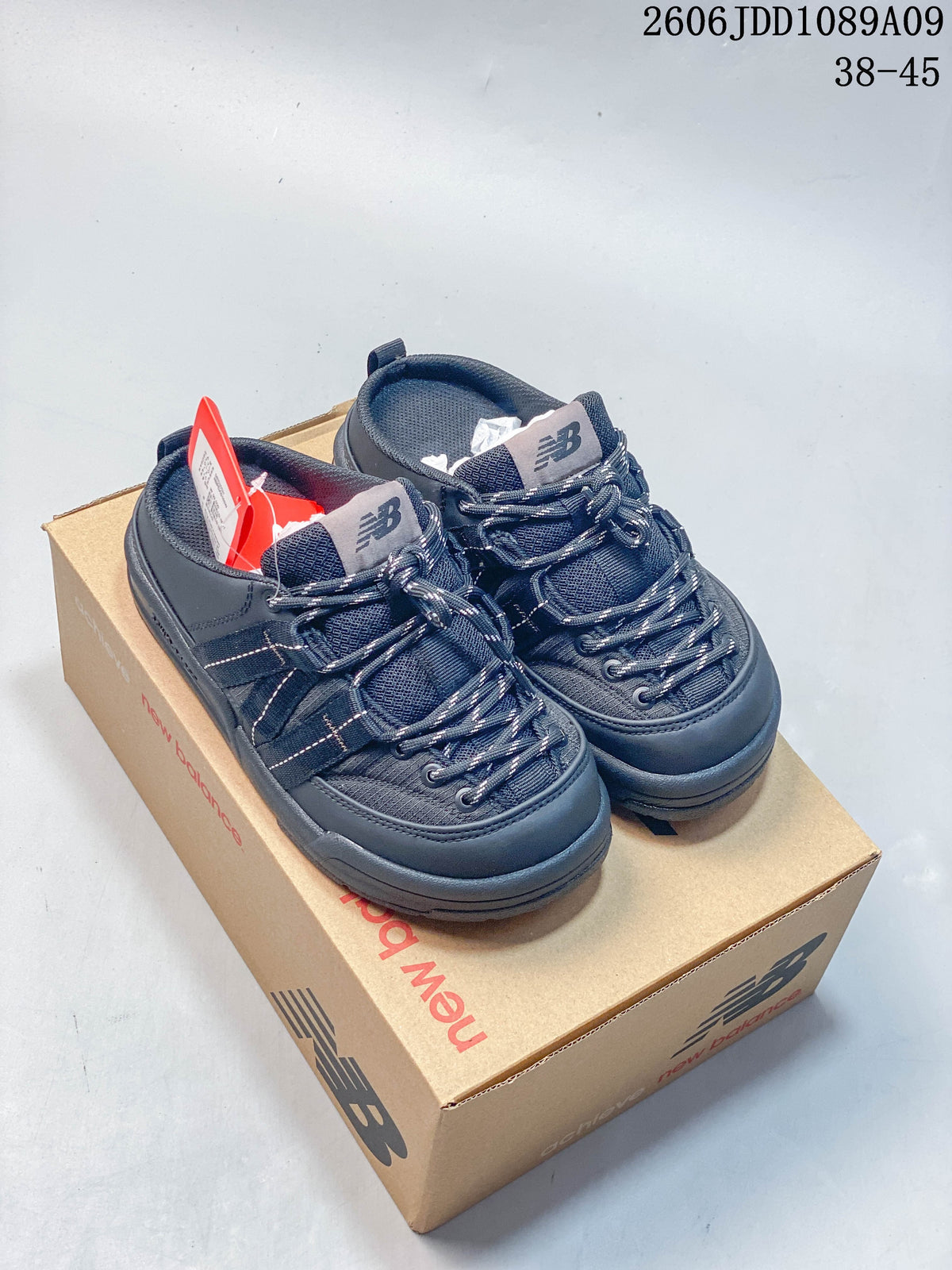 Navy New Balance Terrace Mule shoes shown together on a shoebox.