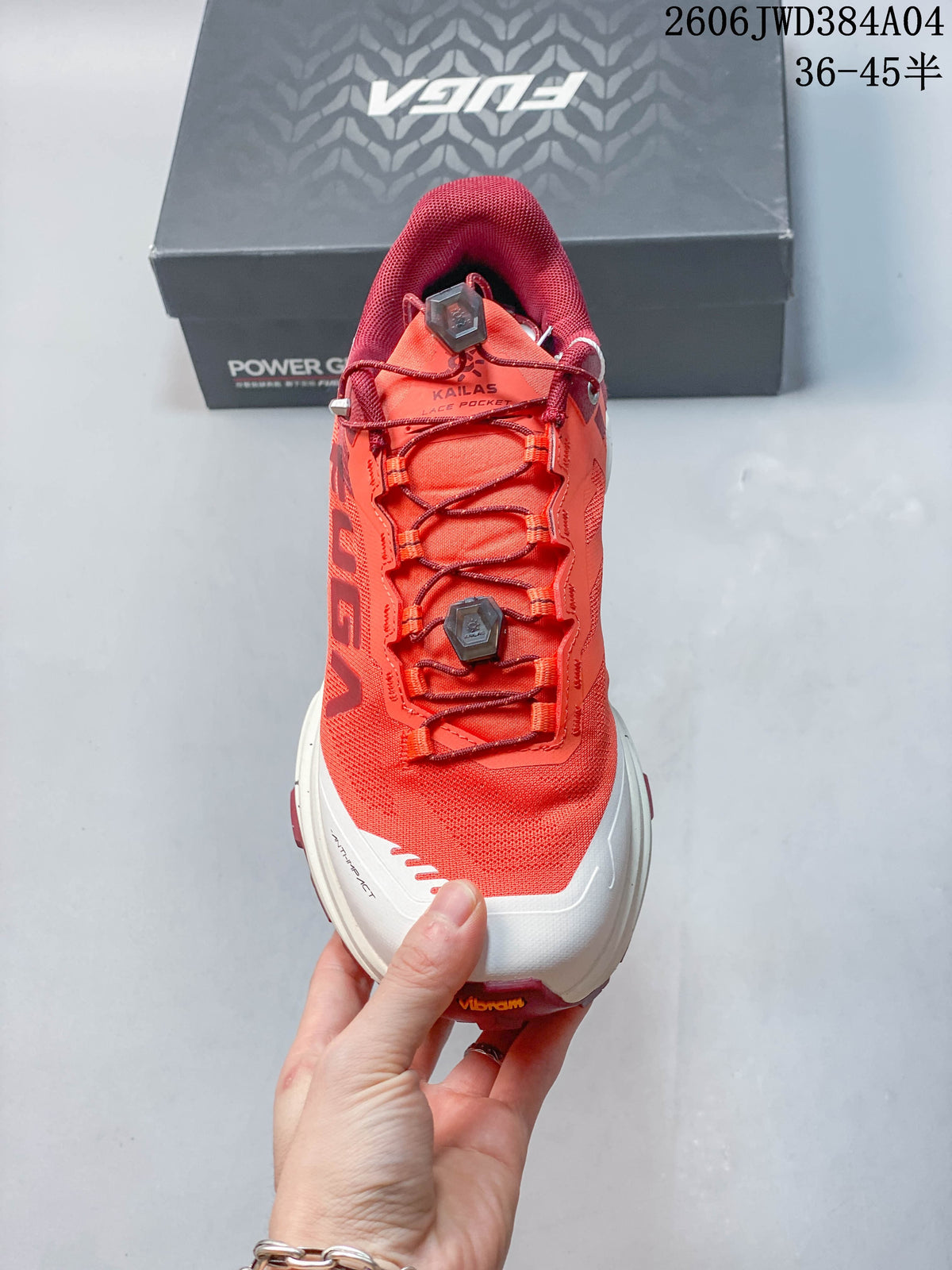 Front view of the shoe showing the coral upper and dial-adjustable laces.
