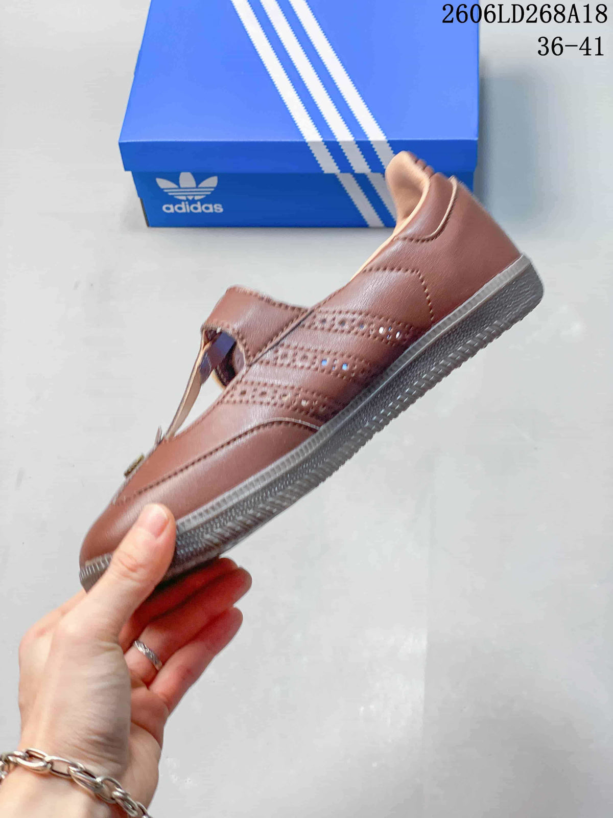 Side view of a brown Samba Jane sneaker with perforated detailing and a gum-colored sole