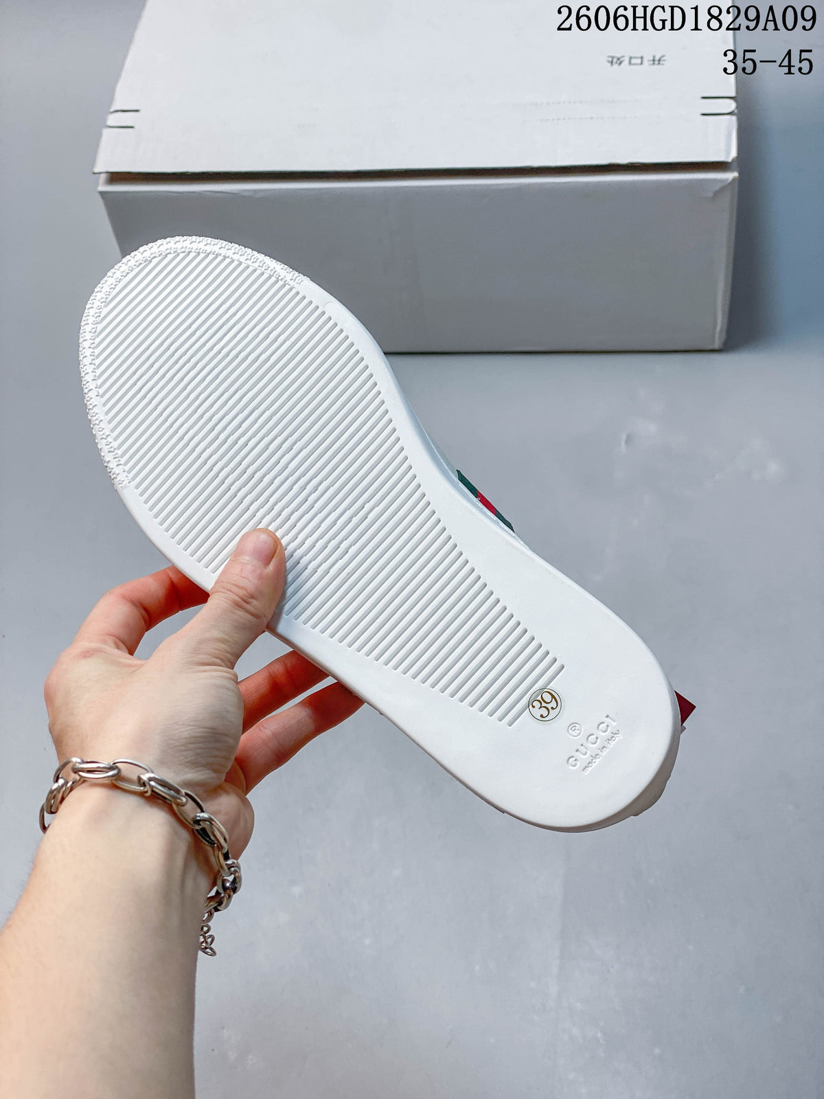 Underside of a white sneaker showing a ridged sole and a size 39 marking.