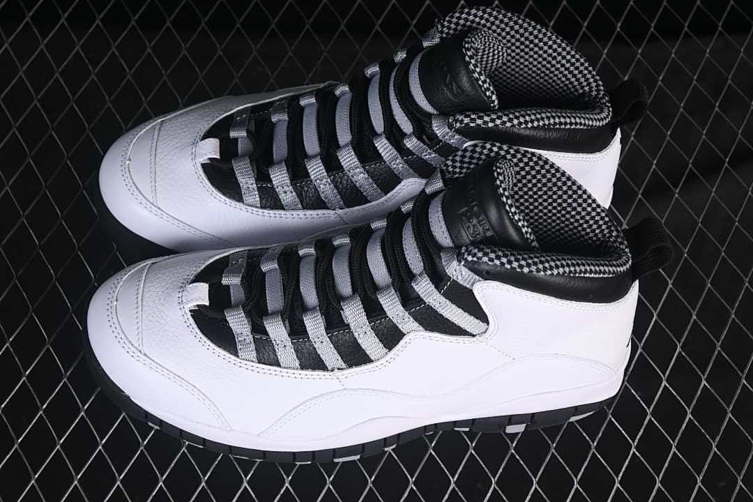 Pair of white, black, and grey Air Jordan 10 Retro sneakers