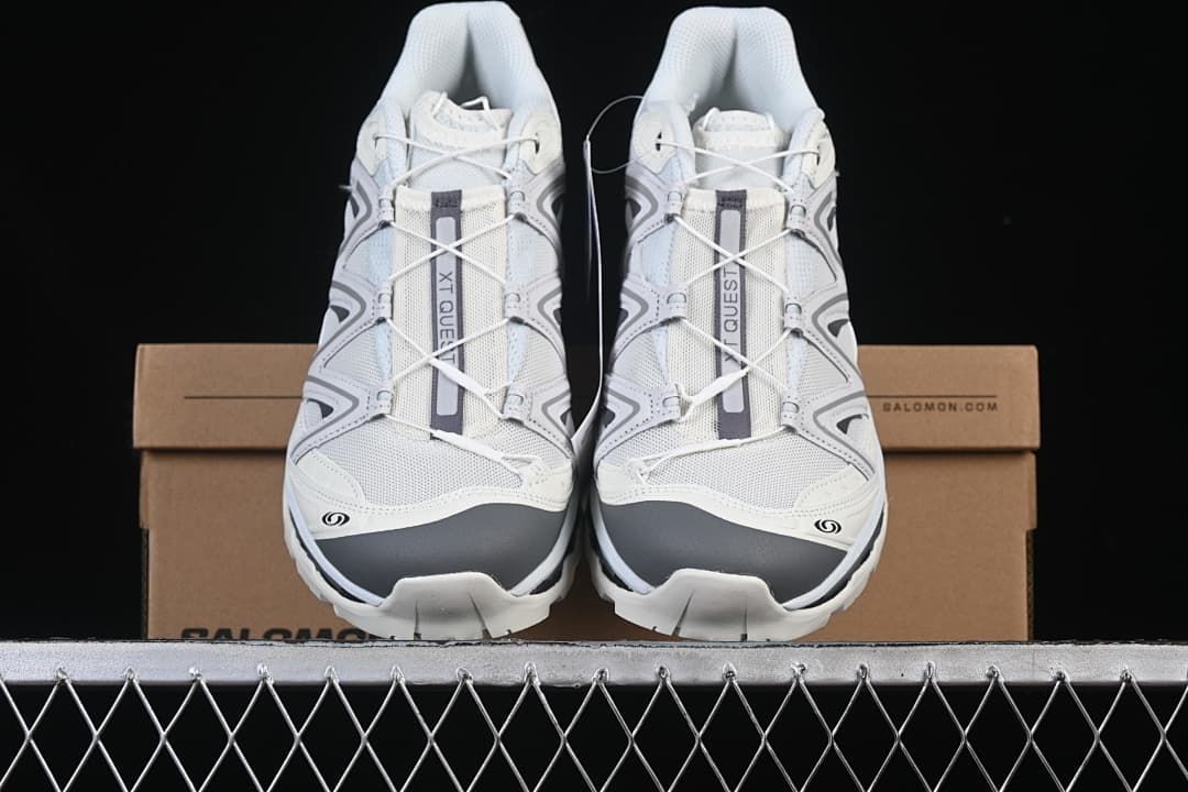 Front view of the pair resting on a Salomon shoebox