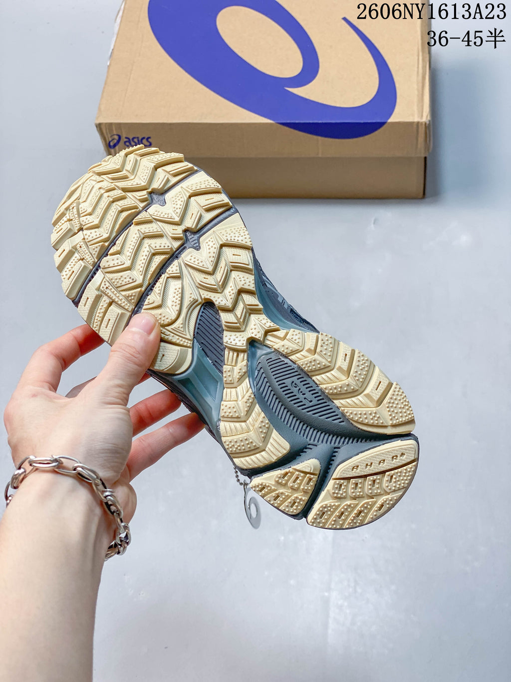 Close-up of the cream-colored outsole and tread pattern on an ASICS Gel-Kahana 8 FL sneaker