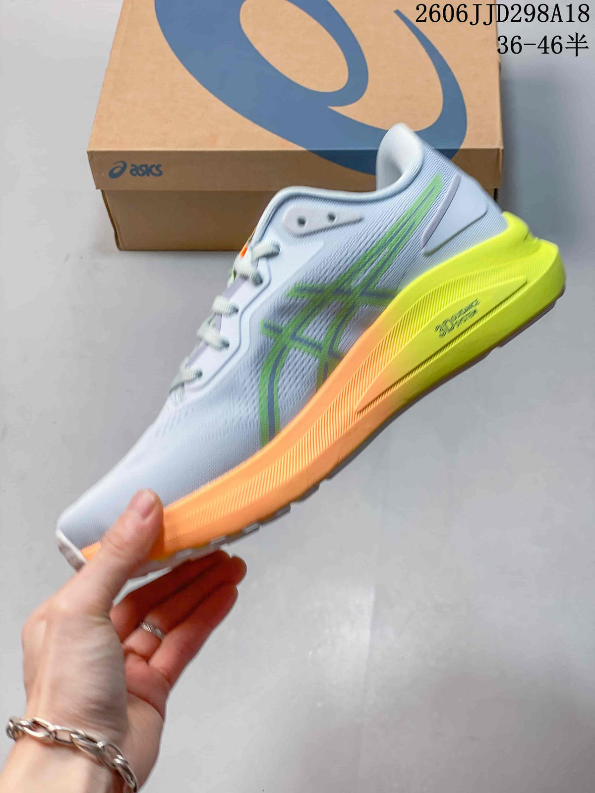 Side view of the pale blue-gray running shoe with lime detailing and orange midsole accents