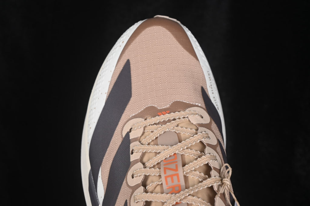 Close overhead view of the toe box, woven upper, laces and dark side stripe details.
