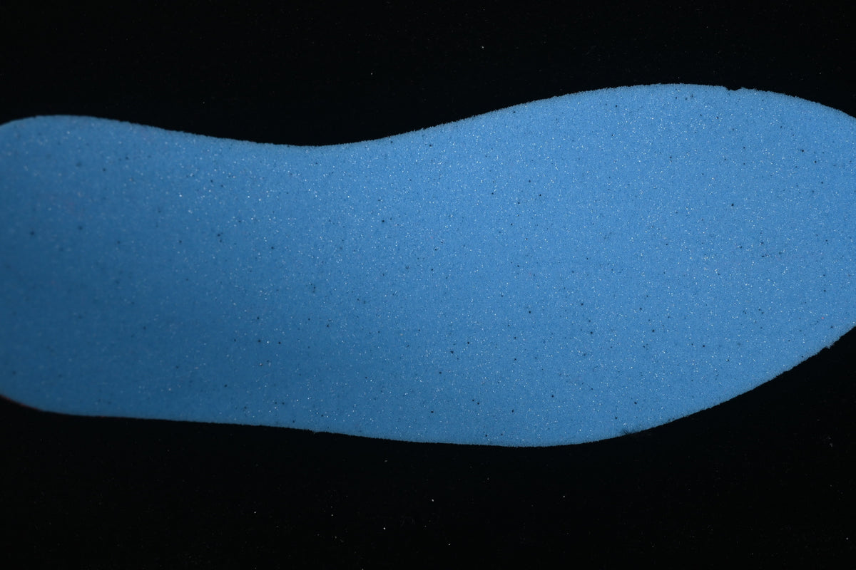 Blue shoe-shaped insert shown against a dark background