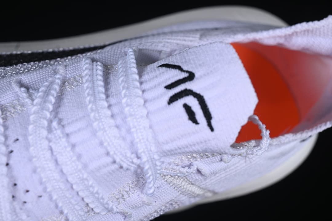 Close-up of the laces, tongue and orange interior