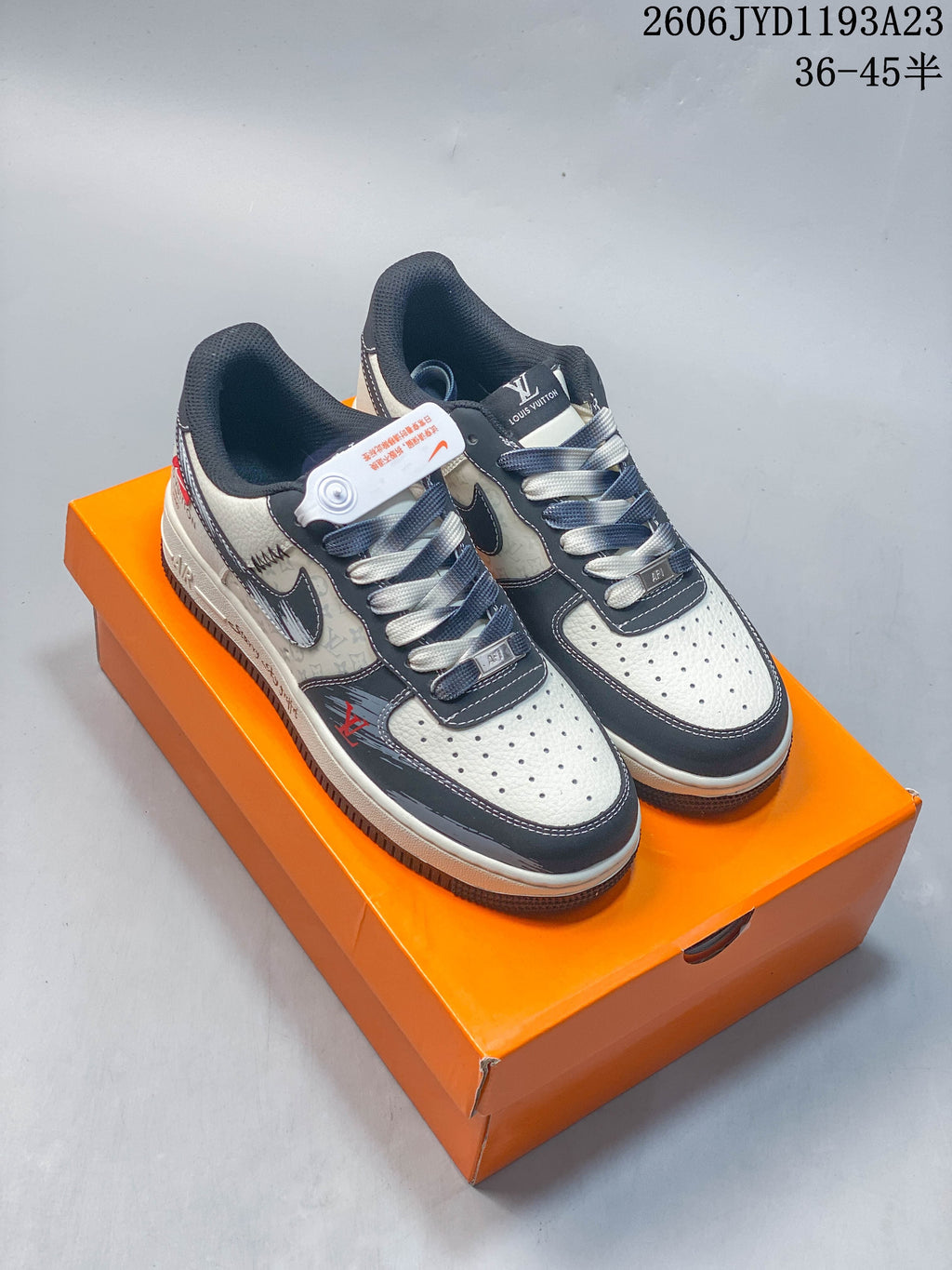 Pair of cream and dark low-top sneakers with patterned panels, contrasting overlays, and mixed-color laces.