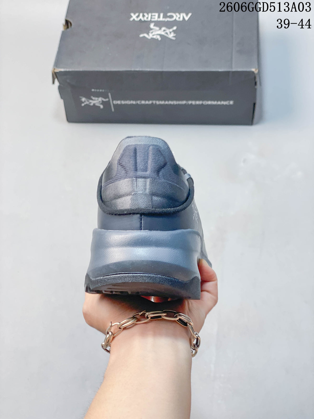 Rear view showing the heel and outsole of the gray-blue outdoor shoe.