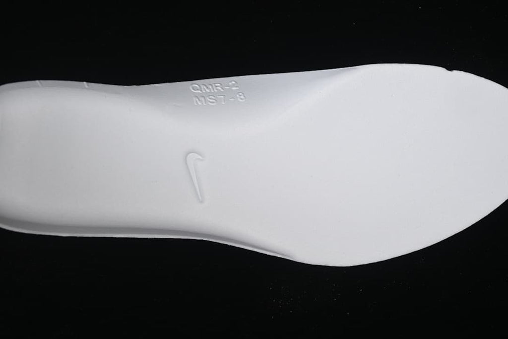 White shoe insert showing an embossed Nike Swoosh.