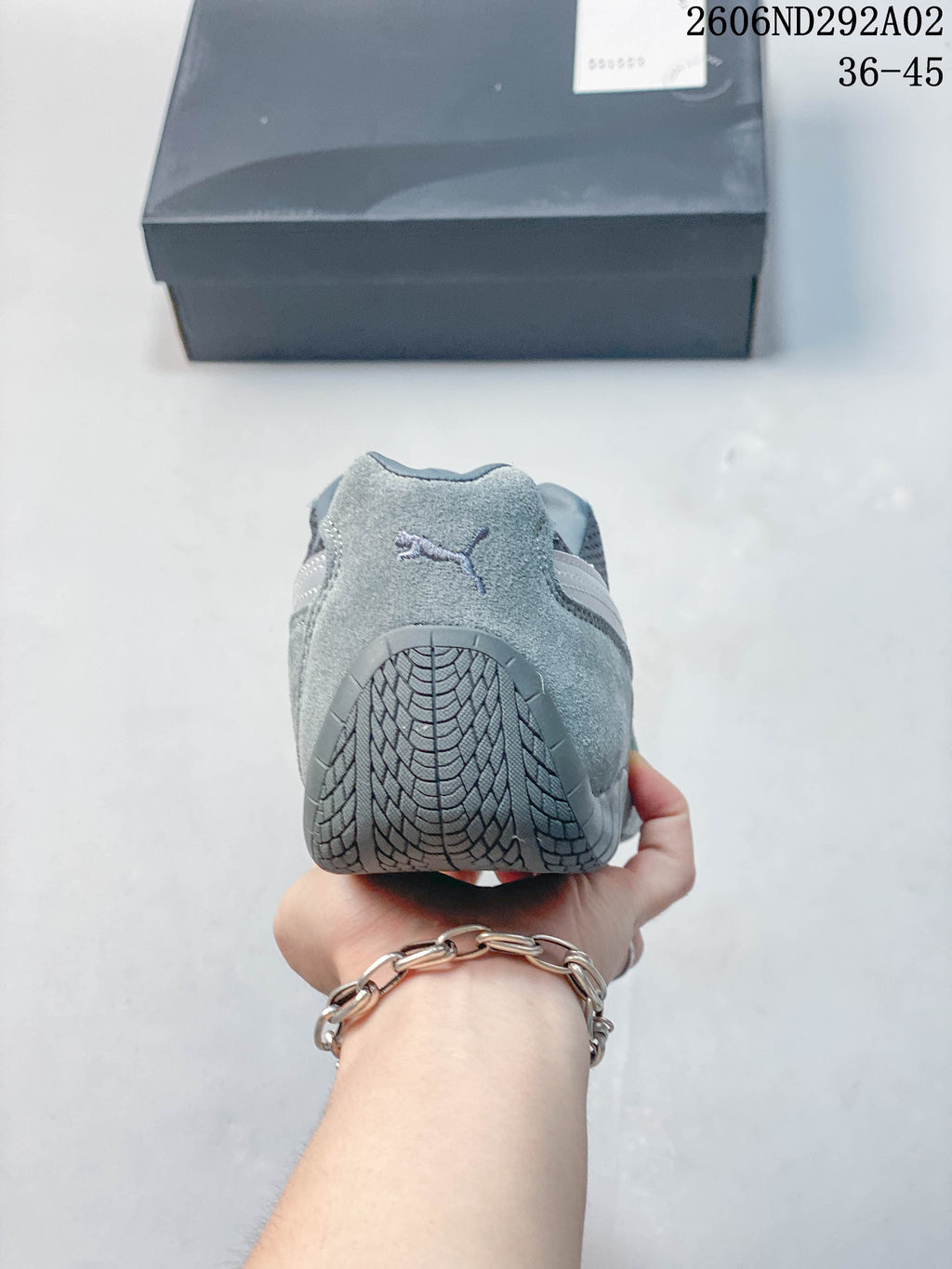 Rear view showing the heel and tread of a gray Puma sneaker