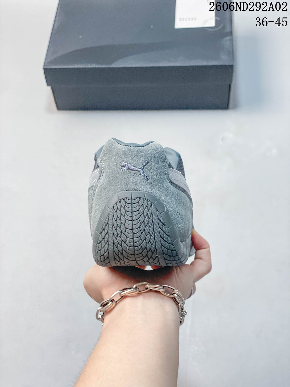 Rear view showing the heel and tread of a gray Puma sneaker