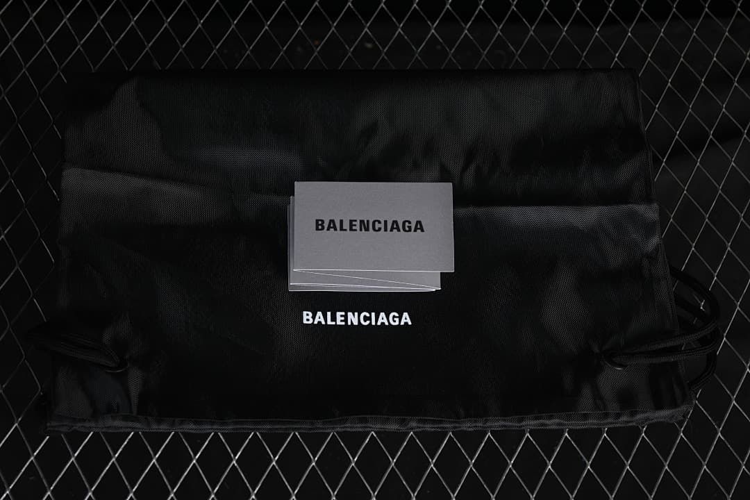 Black branded shoe dust bag and card displayed on a dark background
