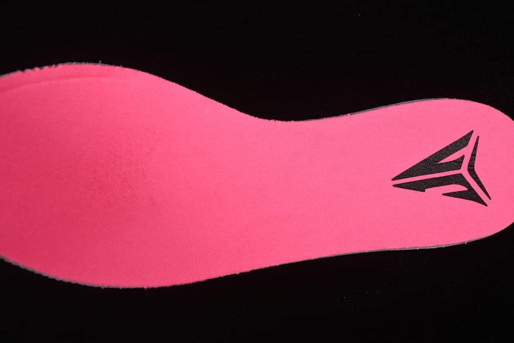 Close-up view of a bright pink shoe insert with a Ja logo