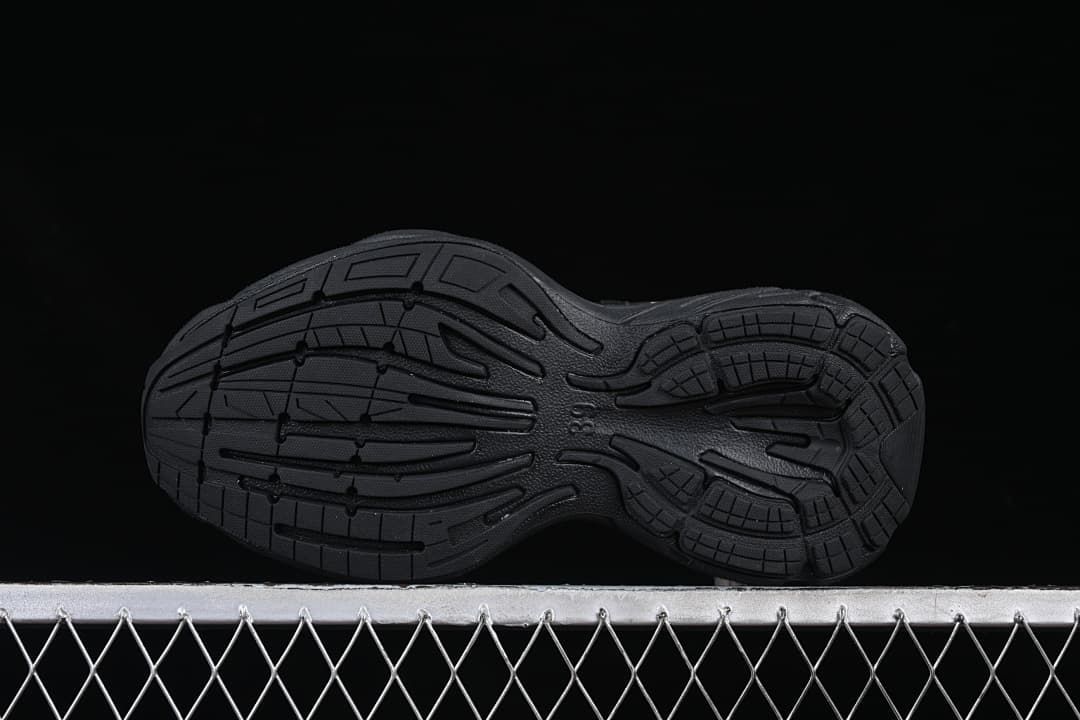 Underside of the black outsole with molded tread pattern