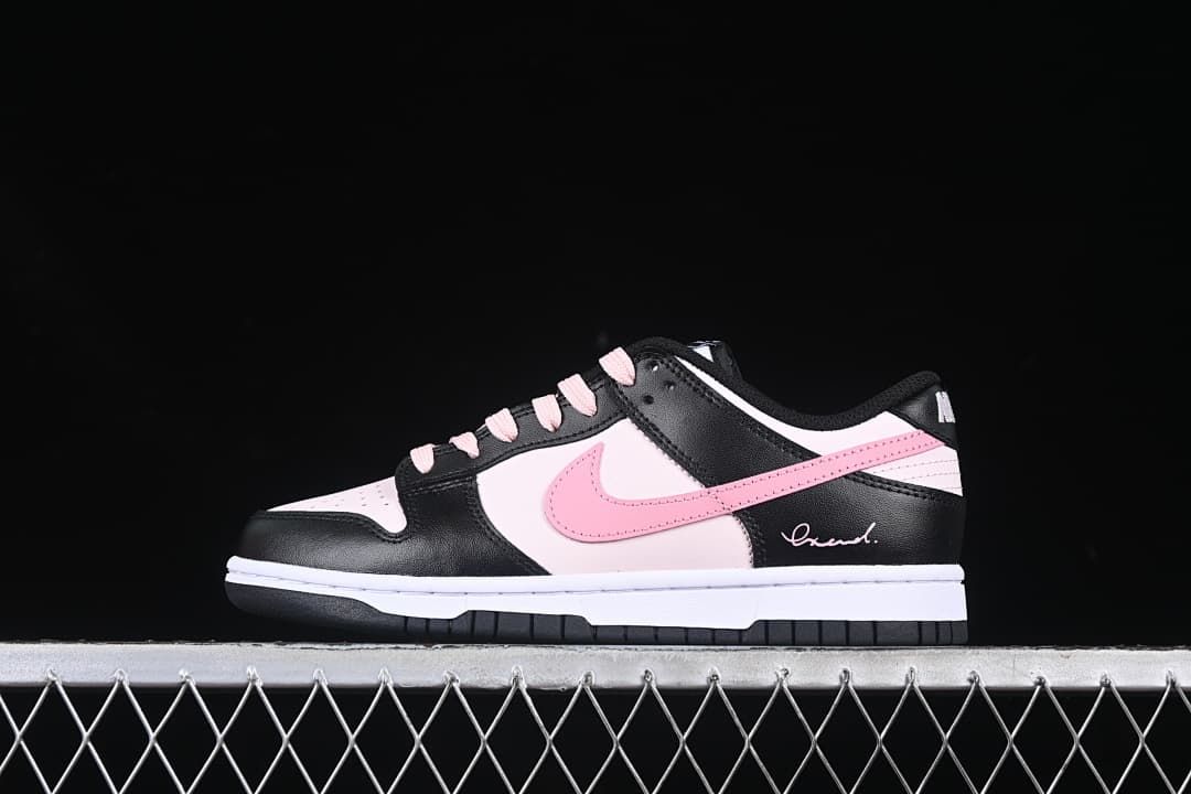 Side view of a low-top black, pale pink, and white Nike Dunk sneaker