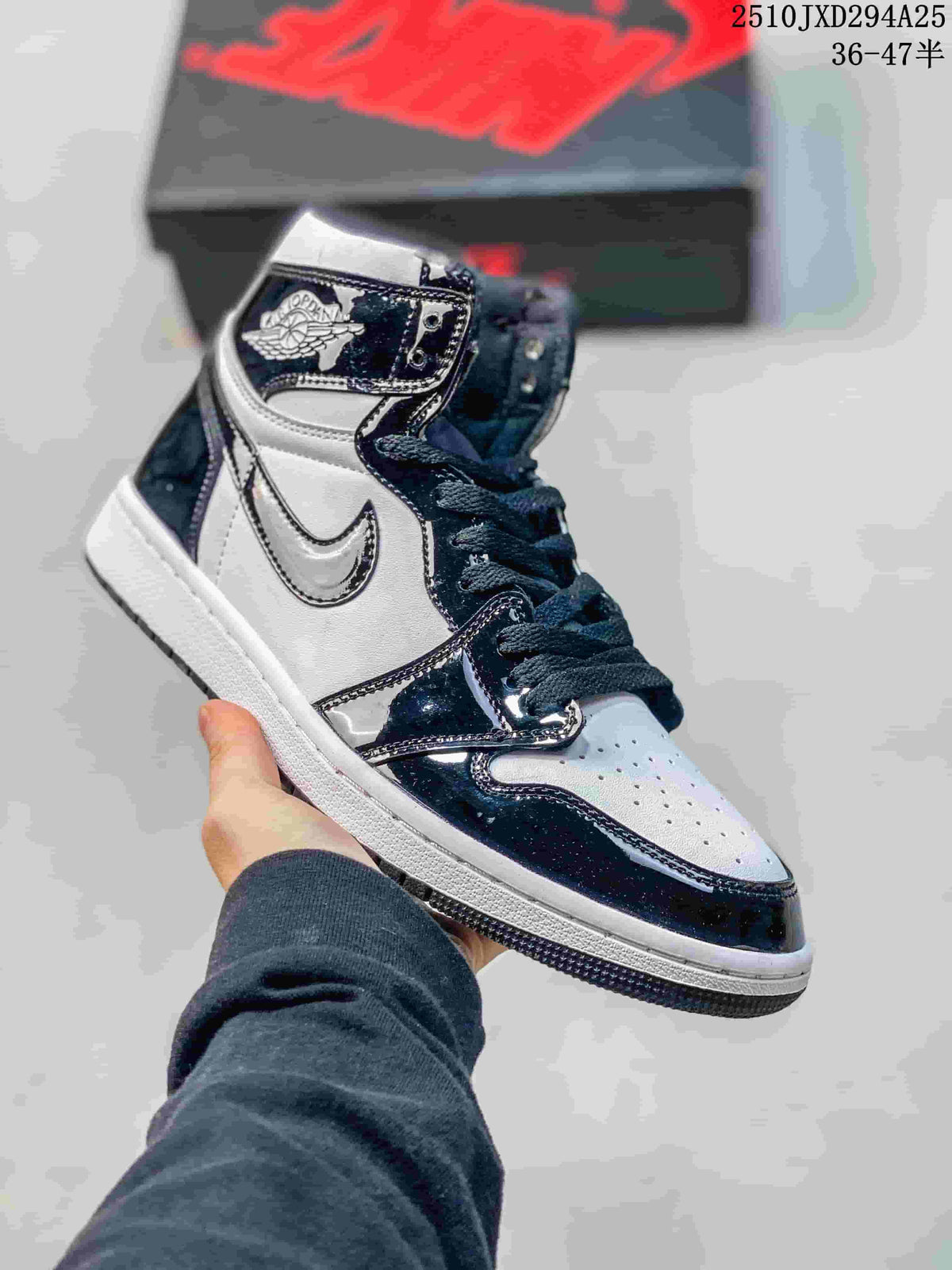 Black and white high-top sneaker with glossy dark overlays