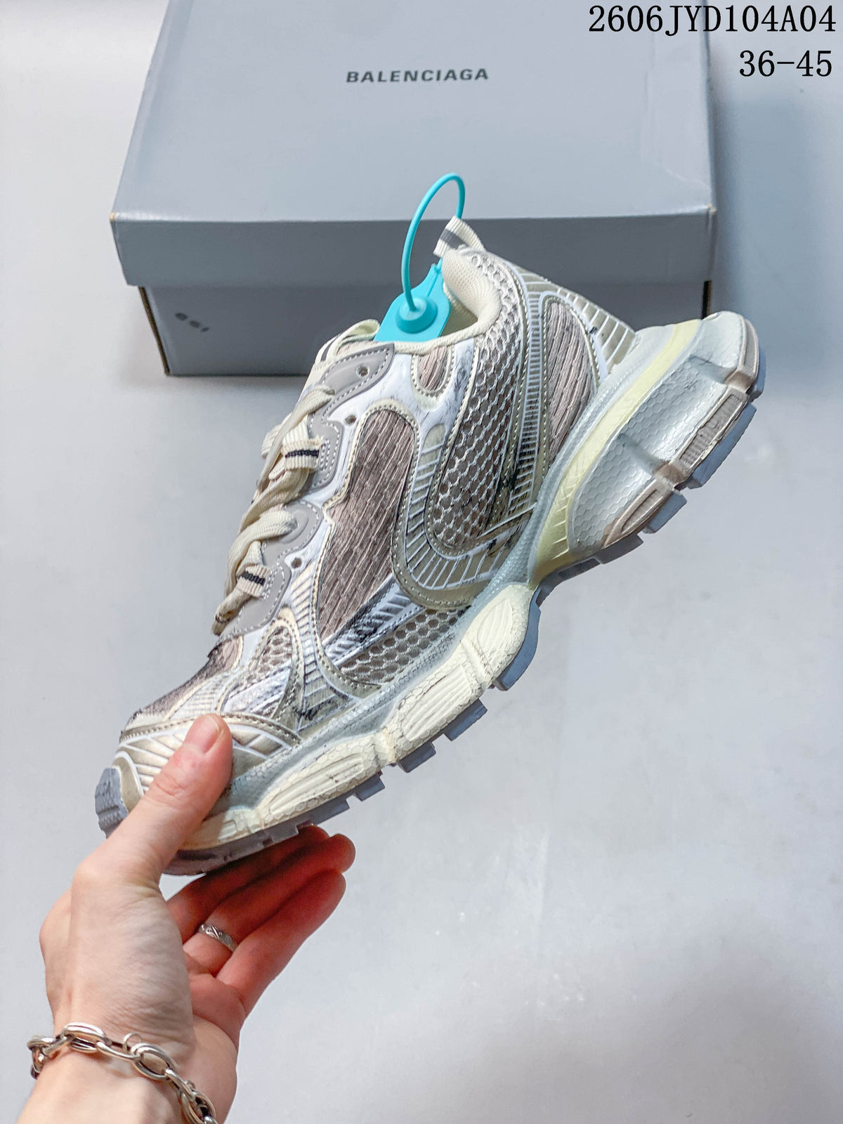 Side view of a layered cream, gray, and muted pink chunky sneaker