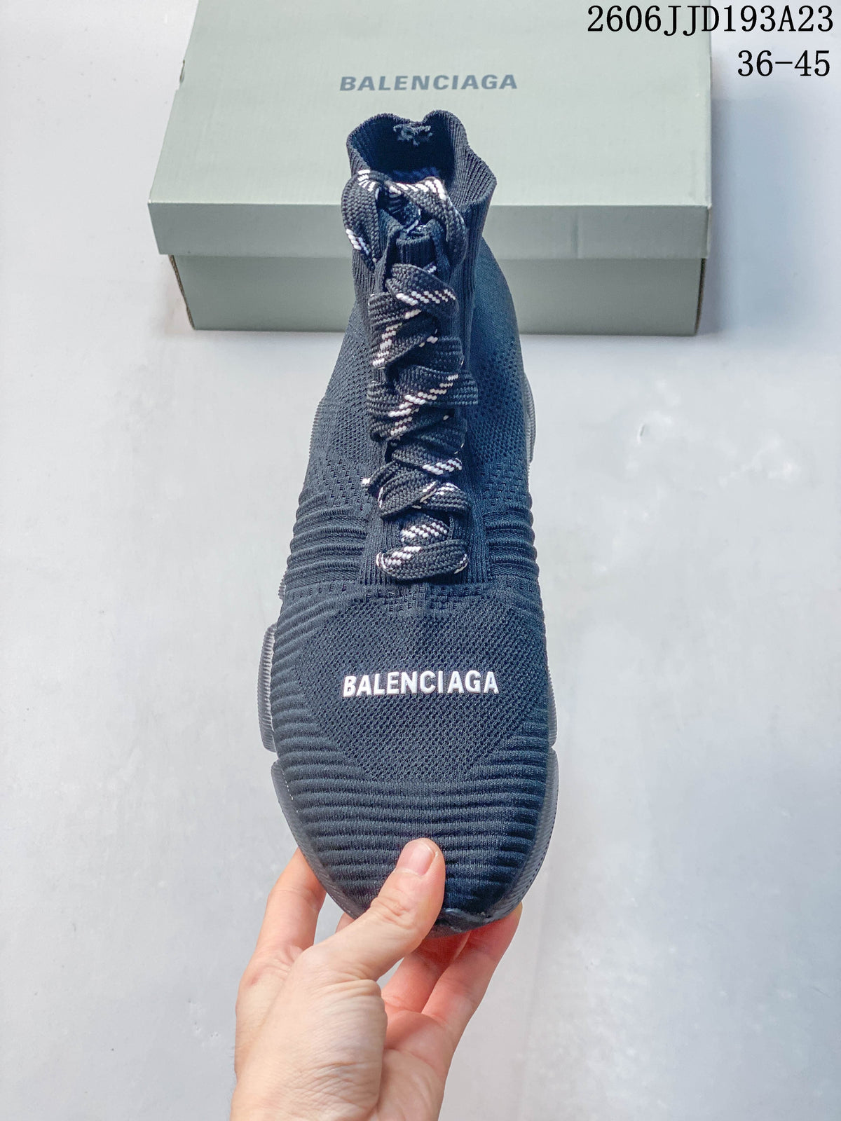 Front view of a navy high-cut sneaker with contrast laces and Balenciaga lettering