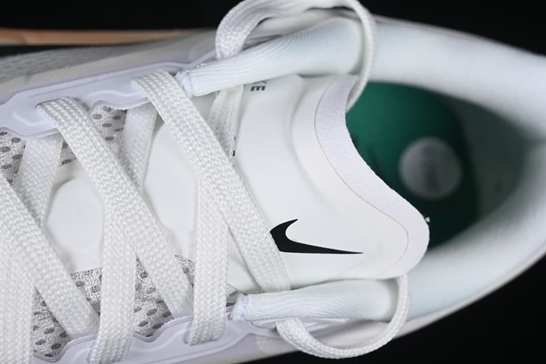 Close-up of white laces, tongue and black Nike Swoosh