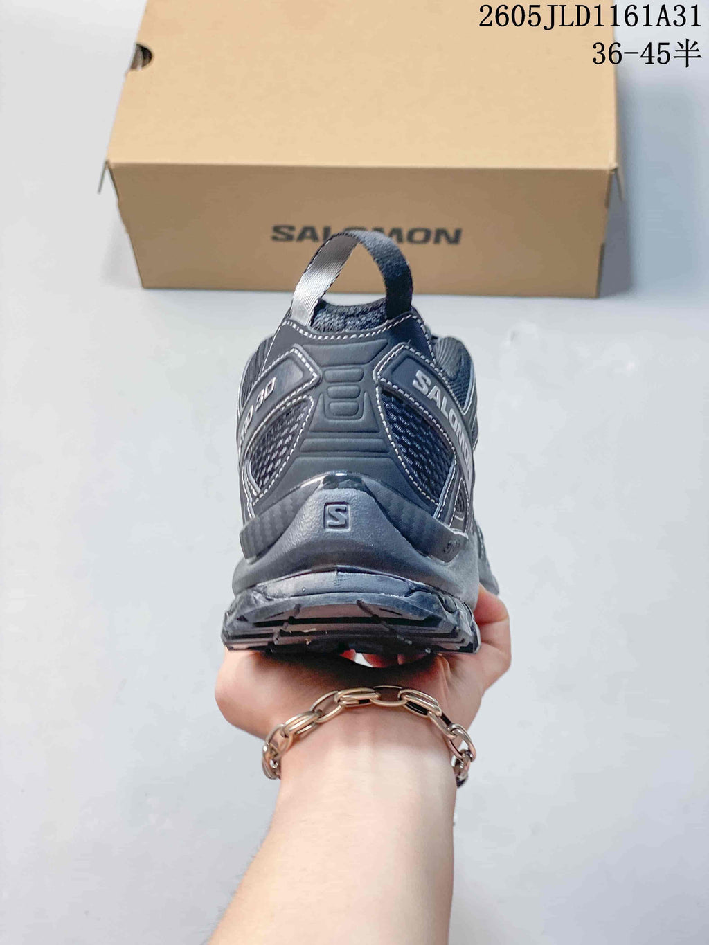 Rear view of a dark gray Salomon XA Pro 3D sneaker with heel pull tab.