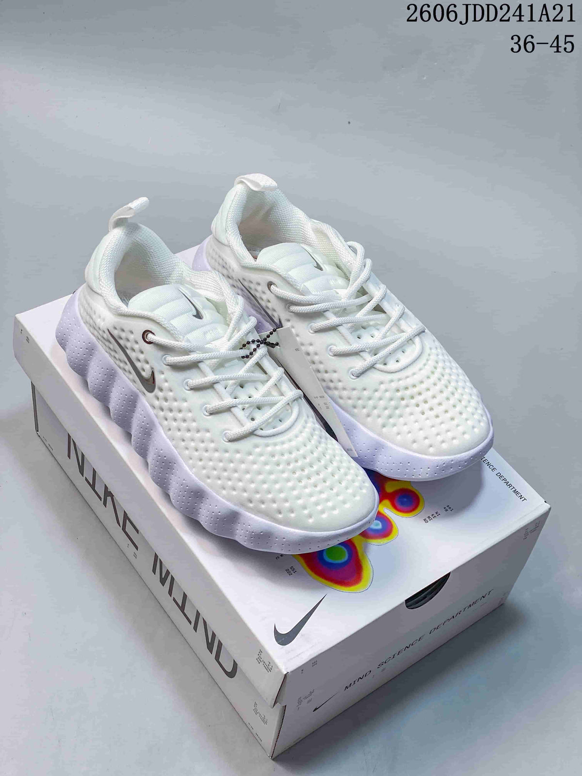 Pair of white Nike Mind shoes with pale lavender accents displayed on the shoe box