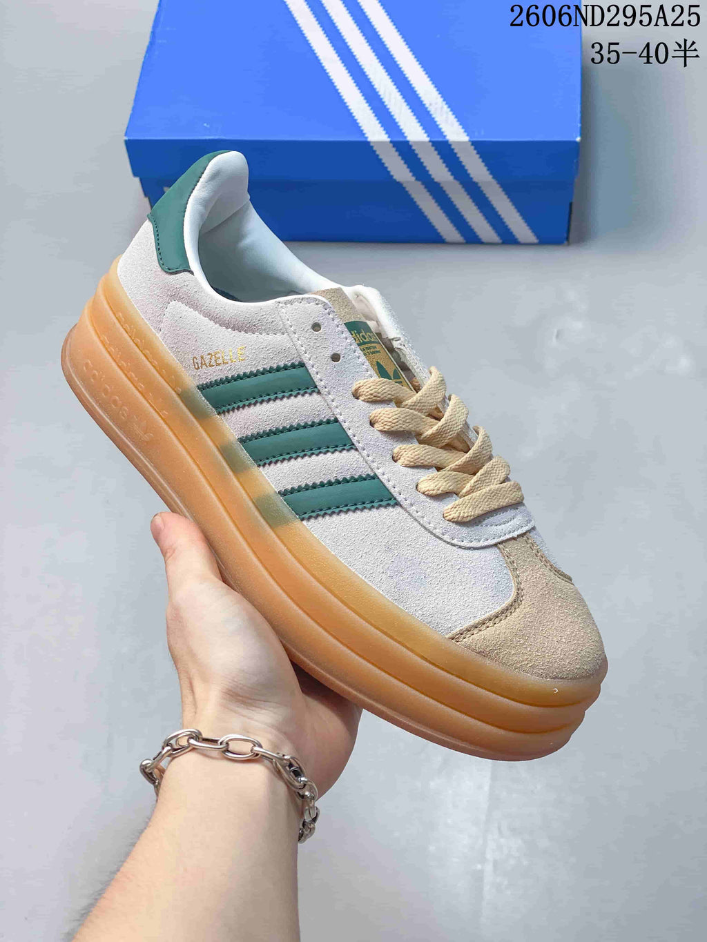 Angled side view of the white and green Gazelle Bold W sneaker