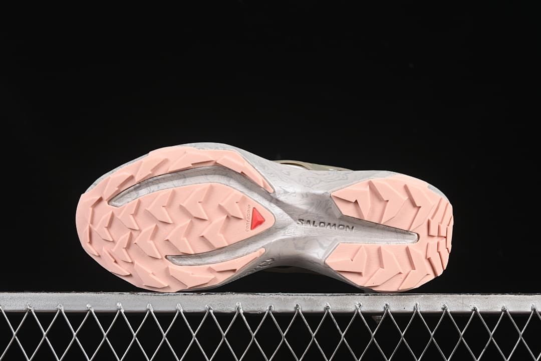 Underside of the shoe showing the lugged pale pink outsole