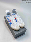 White Onitsuka Tiger Mexico 66 sneakers with blue and red stripes, shown as a pair