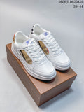 Pair of white low-top lace-up sneakers with beige check-pattern side panels and heel accents