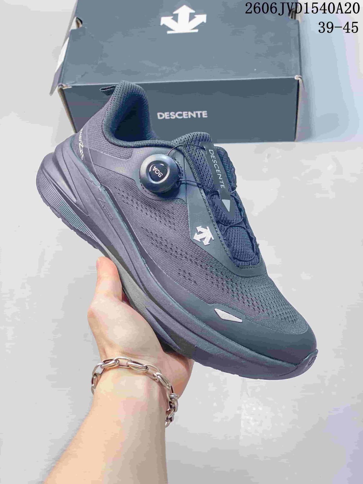 Angled view of a charcoal gray Descente sneaker with a dial-style closure