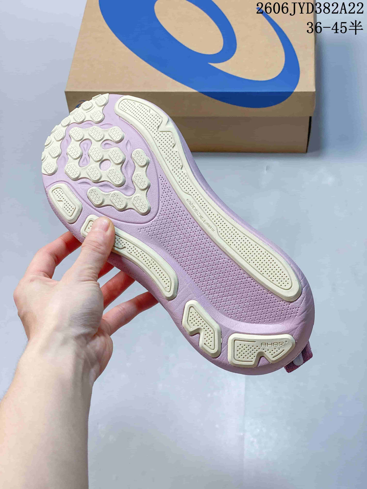Underside of the pink running shoe showing its patterned outsole