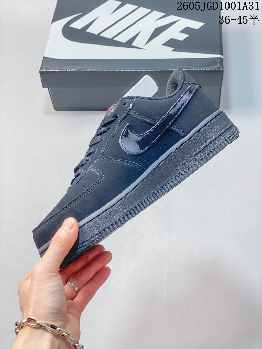 Side view of a dark navy low-top sneaker with a glossy Swoosh