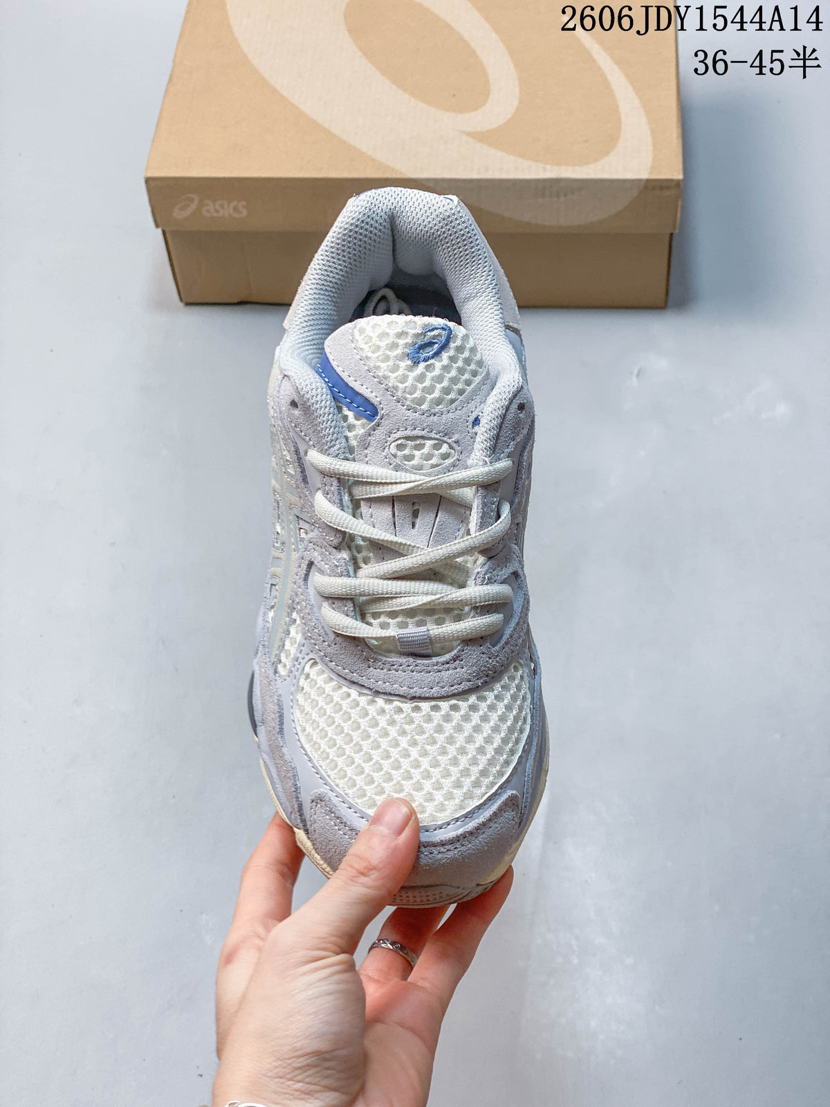 Front view of a sneaker showing mesh toe panel, laces, and layered overlays.