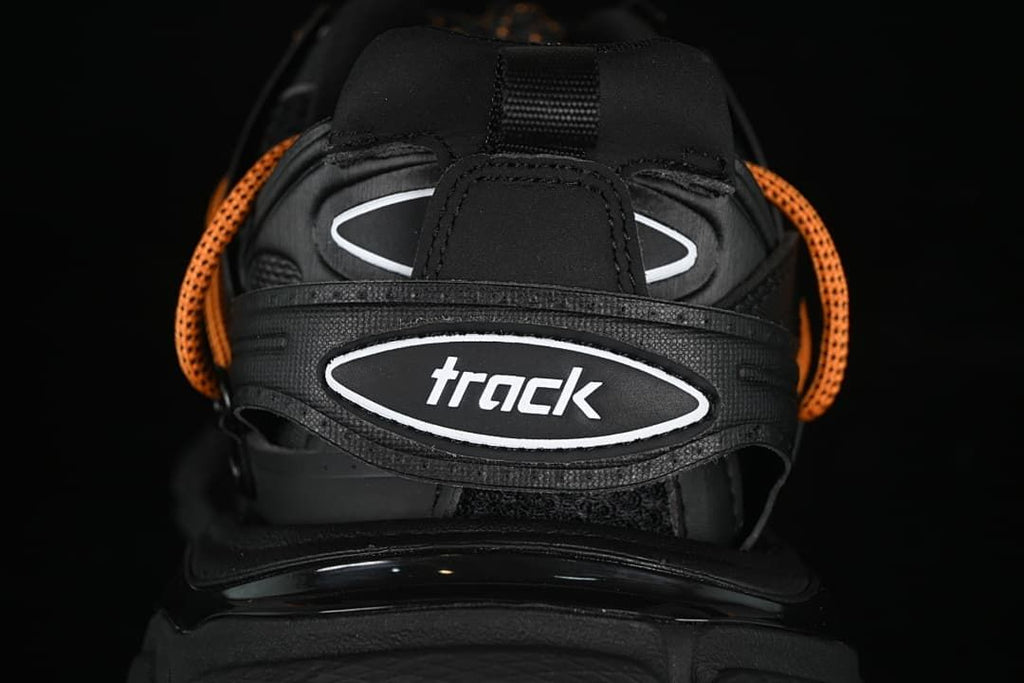 Rear heel detail with Track branding and orange laces.