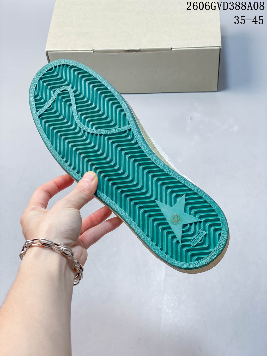 Teal outsole with a raised zigzag tread pattern