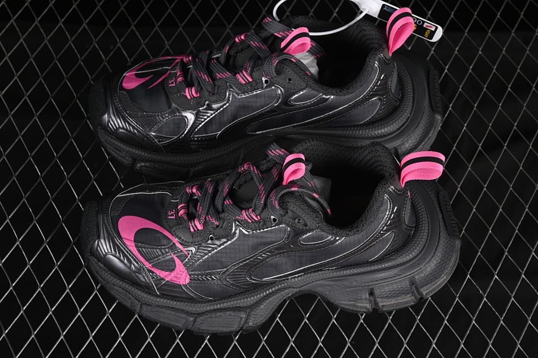 Pair of dark grey and pink sneakers shown from above.