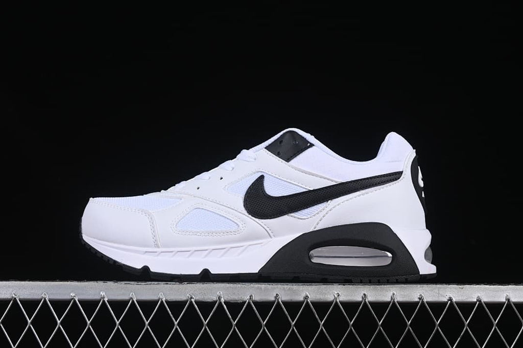 Side view of white and black Nike Air Max Correlate sneakers.