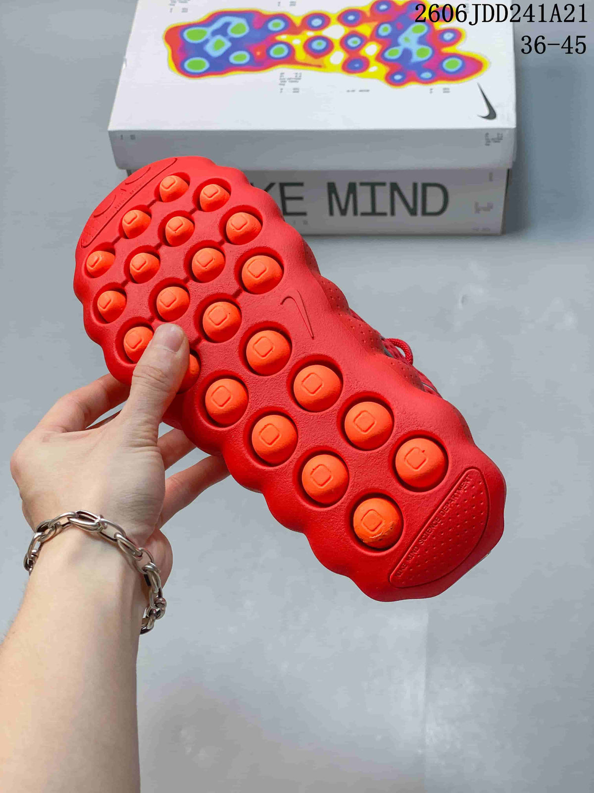 Close-up of the red shoe outsole with raised rounded pods