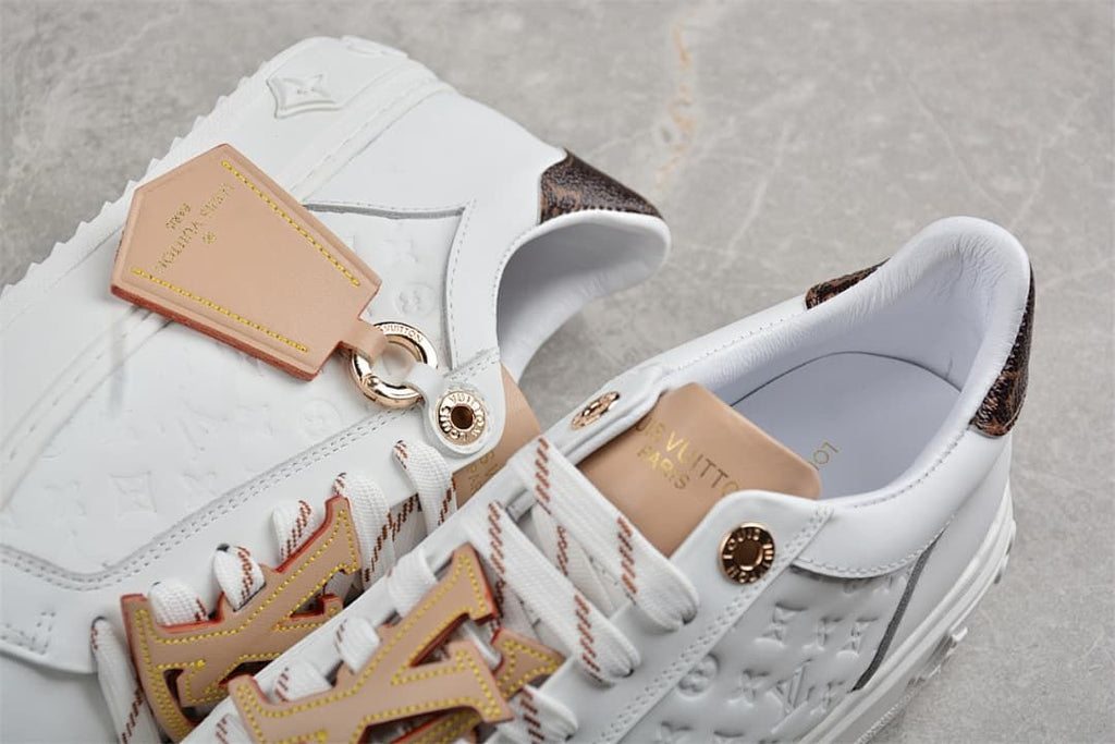 Close-up of the embossed side panel, patterned heel, and decorative lace details