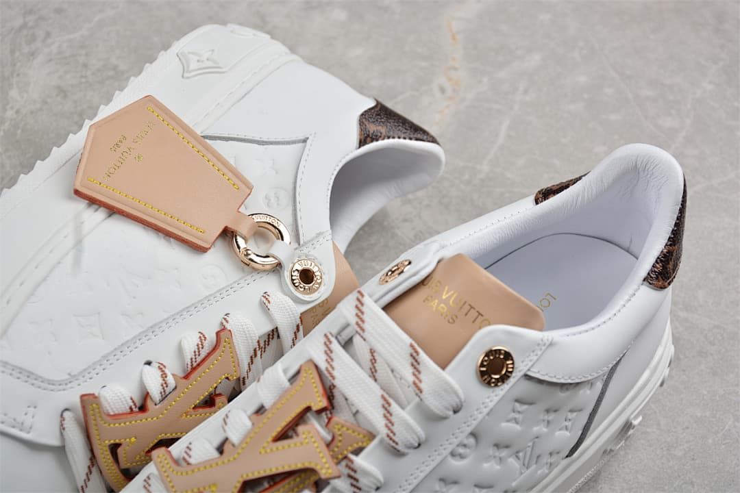 Close-up of the embossed side panel, patterned heel, and decorative lace details
