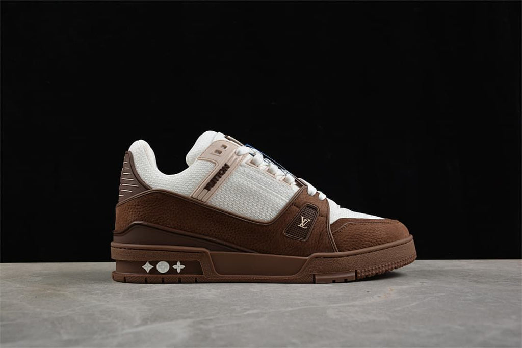 Side profile of the brown and white sneaker with decorative sole details.