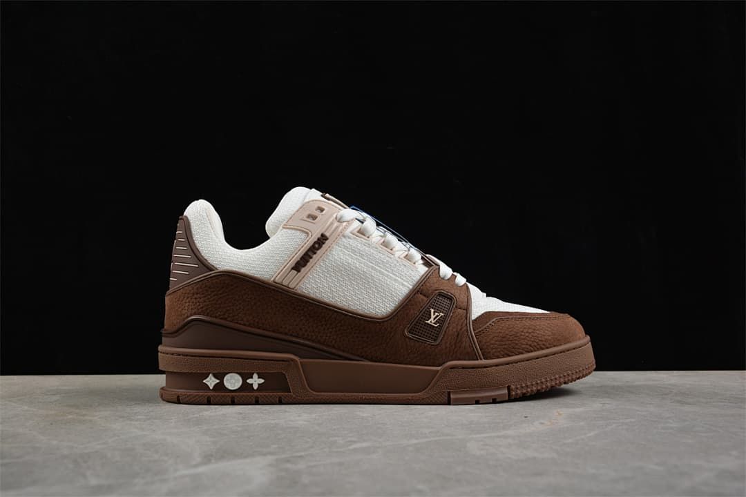 Side profile of the brown and white sneaker with decorative sole details.