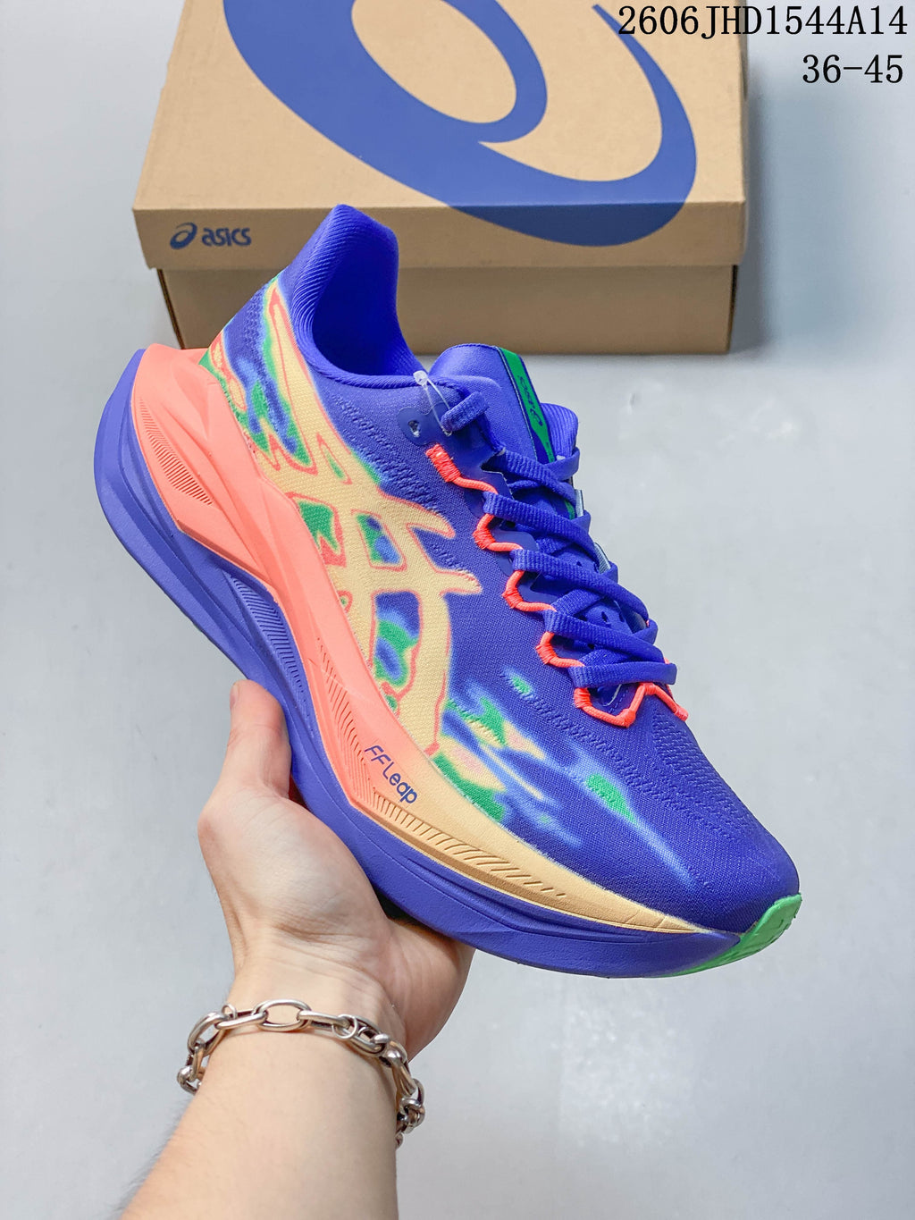 Side view of the purple running shoe with coral and green accents