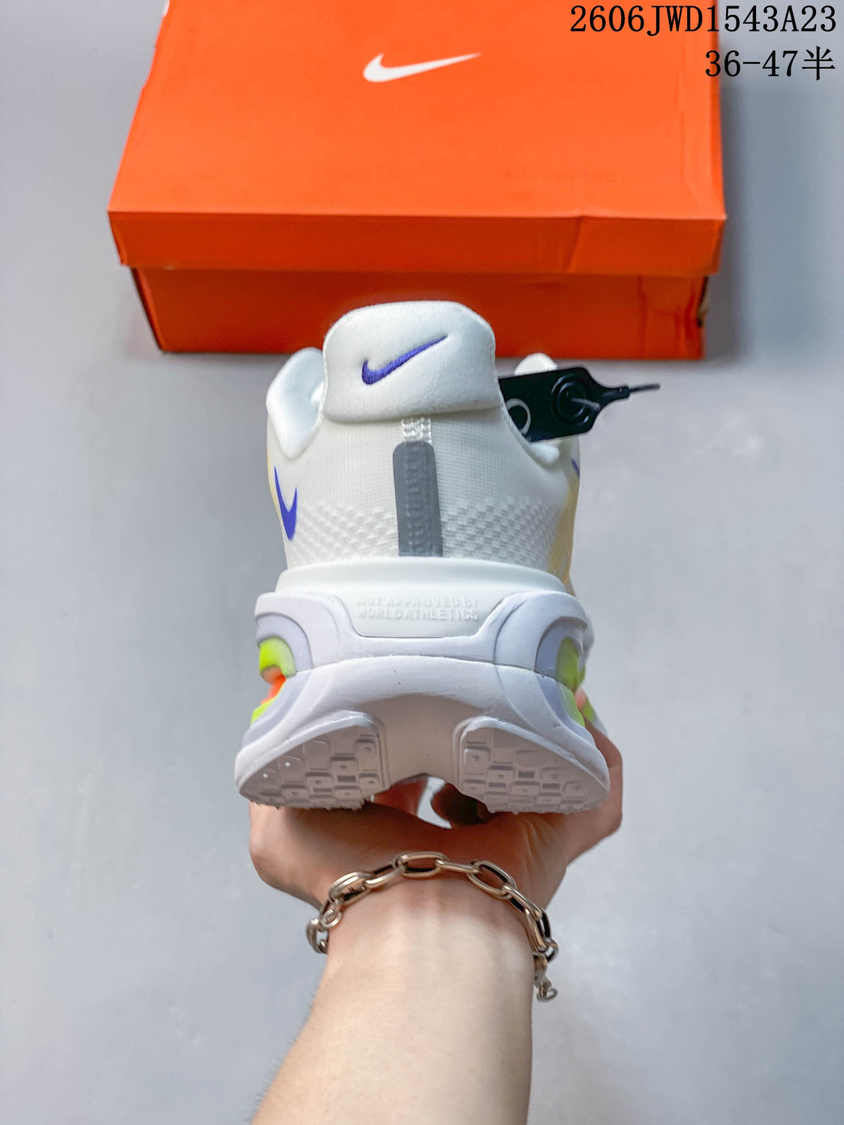 Rear view of the white running shoe with a sculpted heel and colorful cushioning details